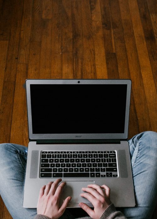 person-in-blue-denim-jeans-sitting-on-floor-using-macbook-4134791